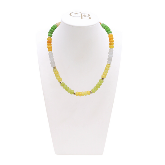 Necklace with green, yellow, and gray beads on a white stand with a visible brand logo. Lemon Drop Daze Beaded Necklace