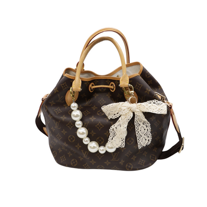 Front view of the Lace Bow Purse Charm on purse