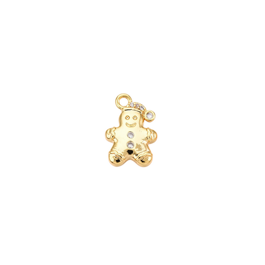 Gold gingerbread man charm with embedded stones on a white background