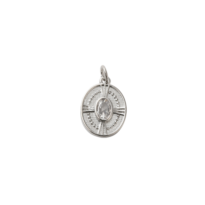 Silver pendant with a central gemstone on a white background