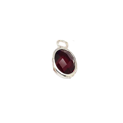 Silver pendant with a red gemstone on a white background