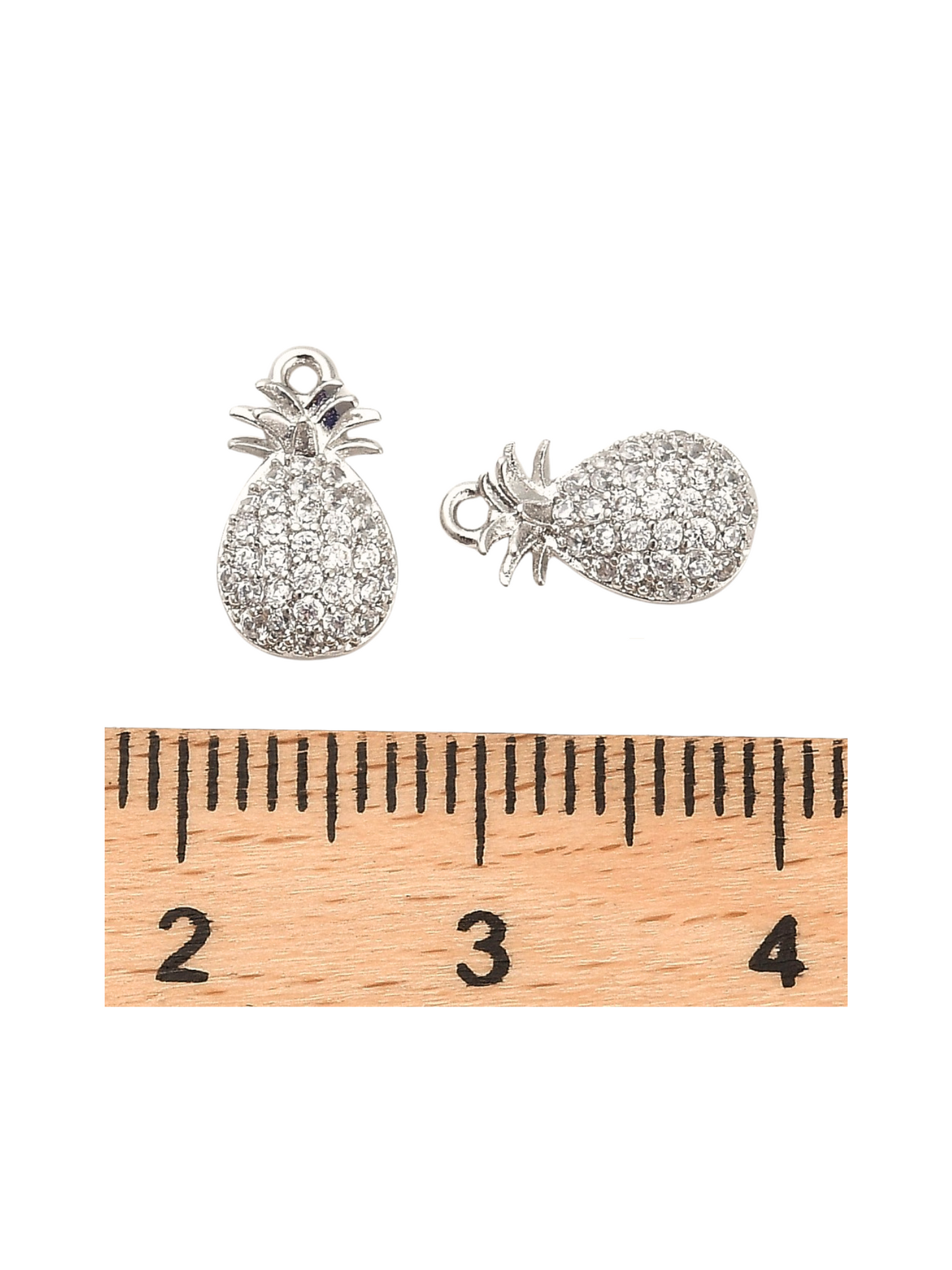 Front of the Silver Pineapple Charm with a ruler