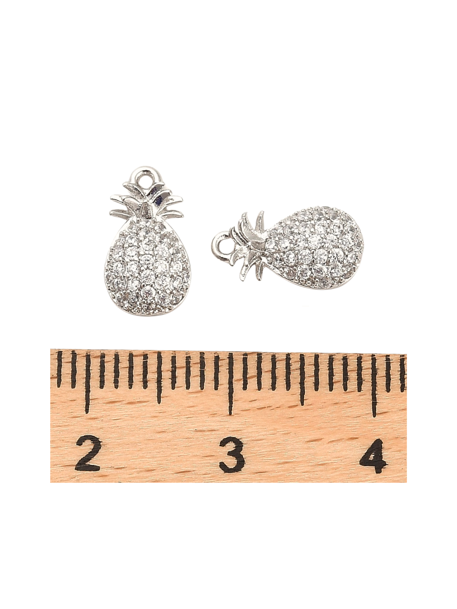 Front of the Silver Pineapple Charm with a ruler