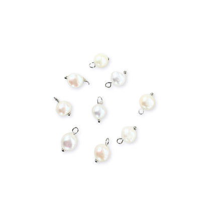 A collection of silver freshwater pearl charms with gold accents, displayed against a white background.
