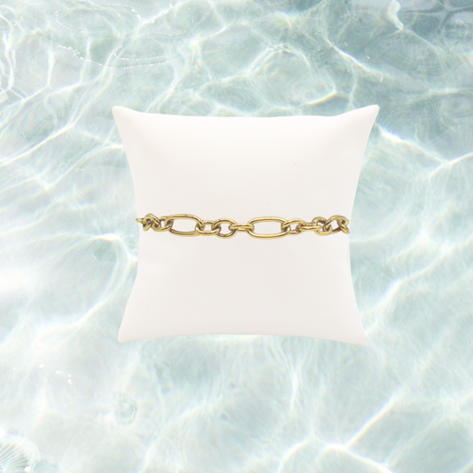 Gold Keepsake Bracelet on water background 