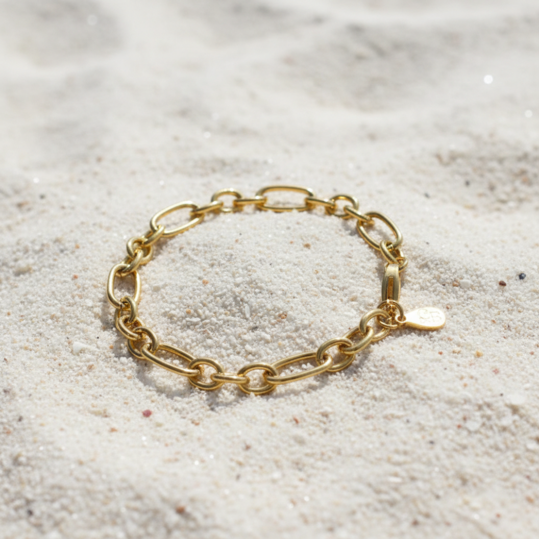 Gold Keepsake Bracelet laying on the sand 