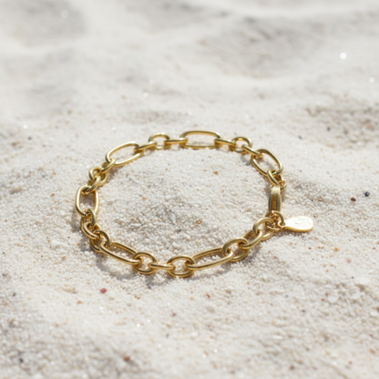 Gold Keepsake Bracelet laying on the sand 