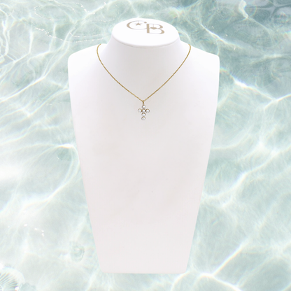 Gold Pearl Cross Necklace | Waterproof, Hypoallergenic & Tarnish Resistant on water background 