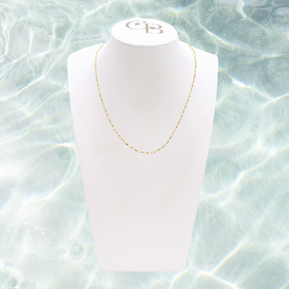 Gold Simple Twist Necklace | Waterproof, Hypoallergenic & Tarnish Resistant on water background