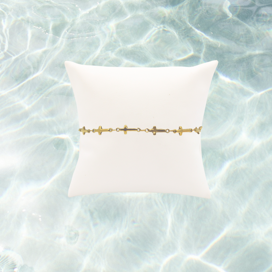 Gold Cross Chain Bracelet | Waterproof, Hypoallergenic & Tarnish Resistant on water back ground 