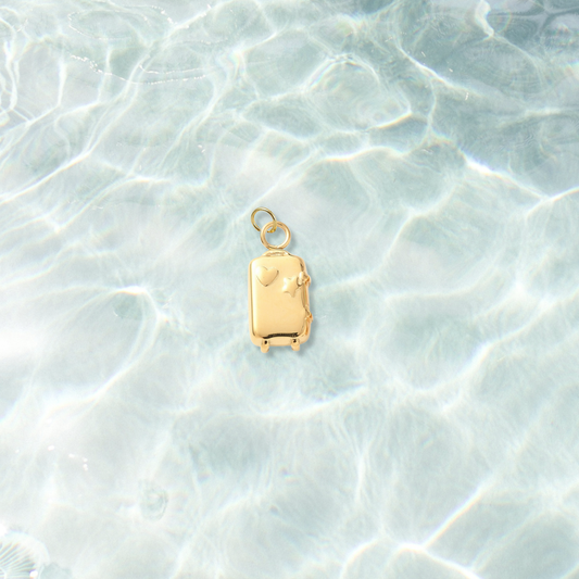 Gold Let's Travel Suitcase Charm | Waterproof Stainless Steel on water background 