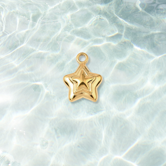 Gold Mini Star Charm on water background