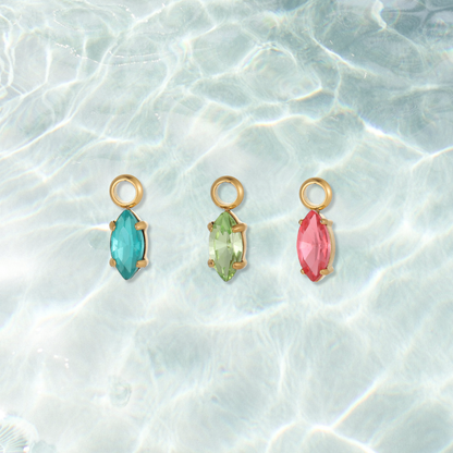 Gold Luminous Marquise Gem Charm on water background 