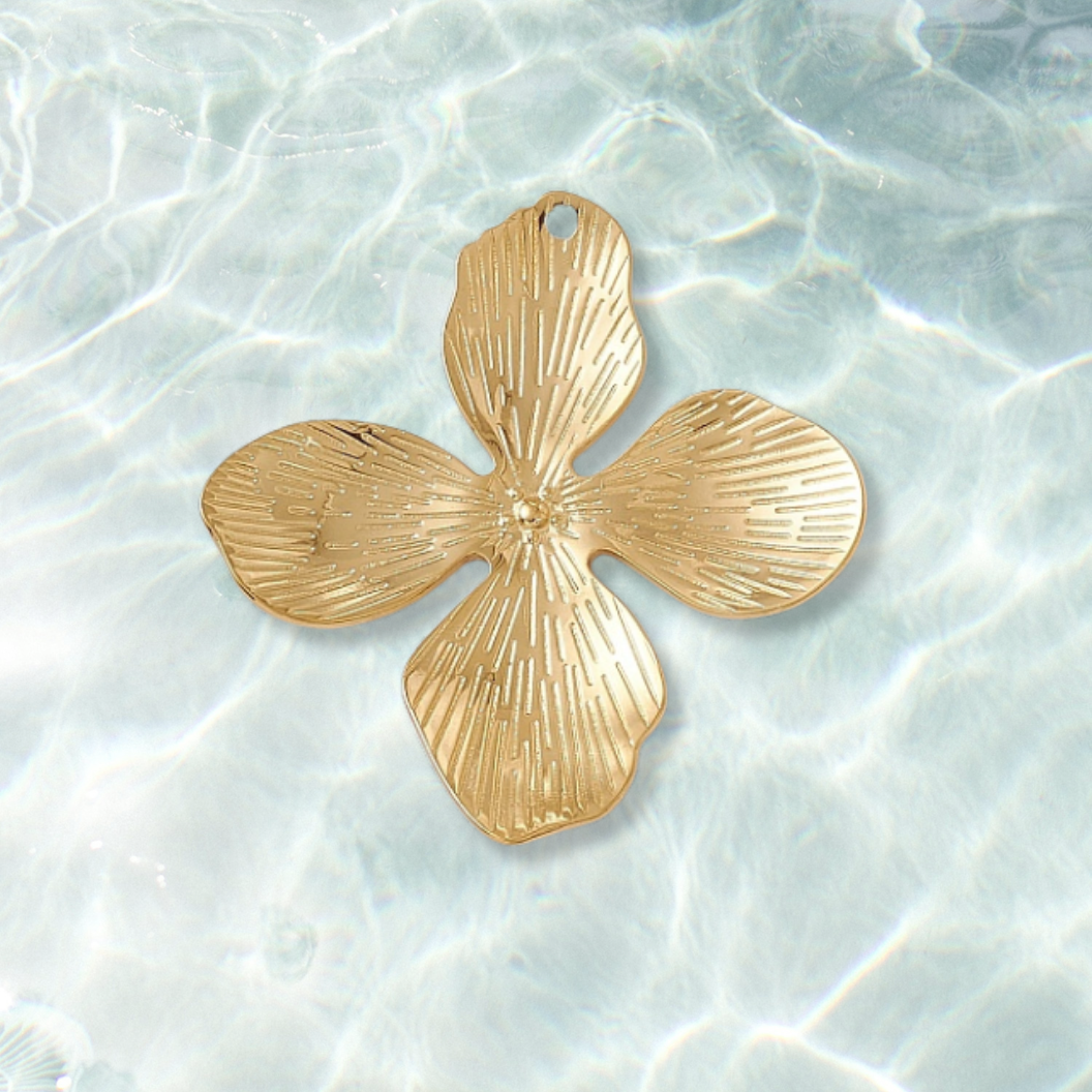 Gold Dogwood Petal Flower Charm on water background 