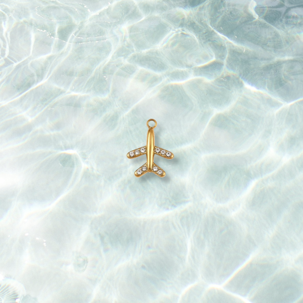 Gold First Class Jet with Rhinestone Charm on water background 
