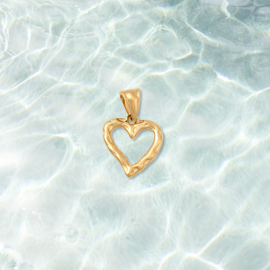 Gold Open Hammered Heart Charm on water background 