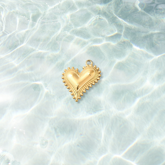 Gold Trinity Heart Burst Charm  on water background