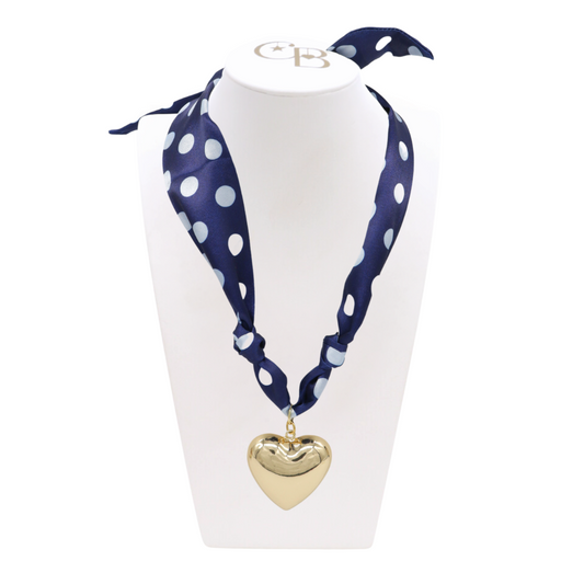 Front view of the Navy Polka Dot Scarf Necklace with Gold Embrace Heart Charm on CB Bust