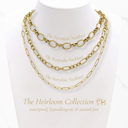 Gold chain necklaces on a mannequin with 'The Heirloom Collection' branding.