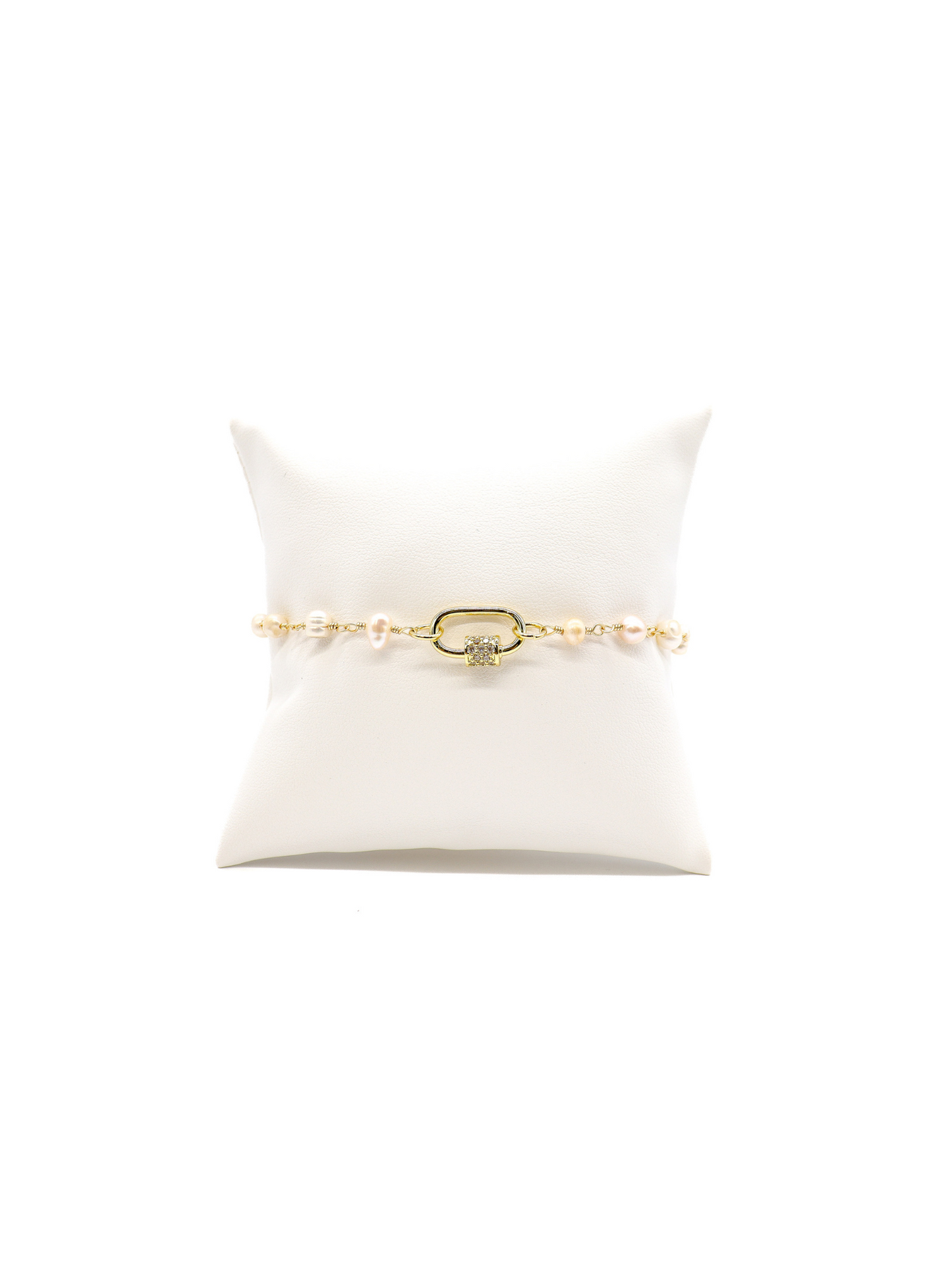 Beth pearl bracelet with Gabi white crystal carabiner on white cushion.