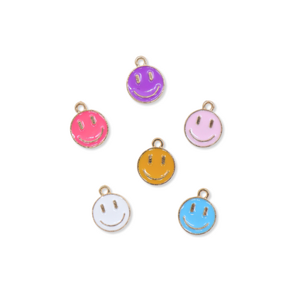 A collection of gold smiley face charms in assorted colors including purple, pink, yellow, white, and blue.