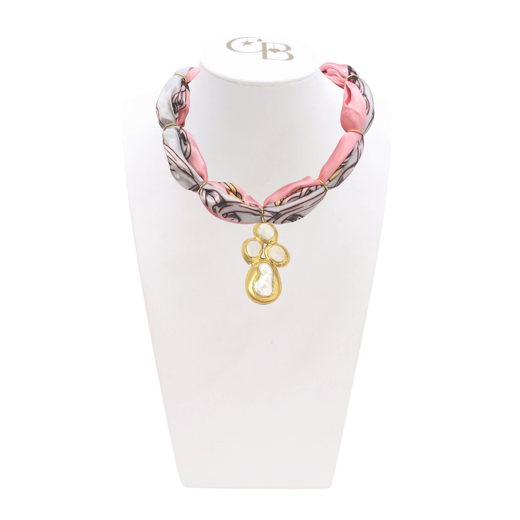 Front of the Gold and Black Pave Leopard Heart Charm with Gold Seaborn Cross Charm on CB Bust