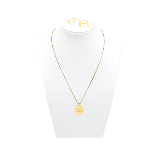 Alpha Chi Omega gold box chain necklace with large oval charm displayed on which necklace bust front view with horizontal greek letters