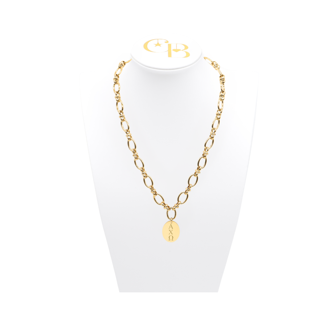 Alpha Chi Omega gold large link evermore necklace with large oval charm with vertical greek letters on white necklace bust front.