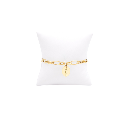 Alpha Epsilon Phi gold large link keepsake bracelet with small oval charm displayed on white pillow front view with horizontal greek letters