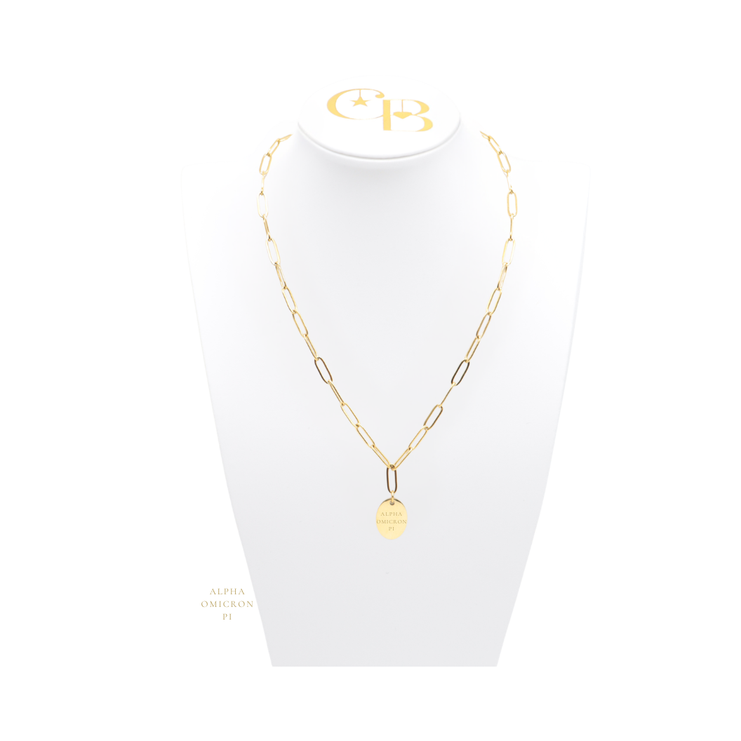 Alpha Omicron Pi gold link storyline necklace with small oval charm with vertical/stacked greek letters on white necklace bust front view