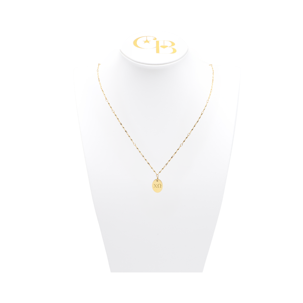 Chi Omega gold link storyline necklace with small oval charm with horizontal greek letters on white bust front view
