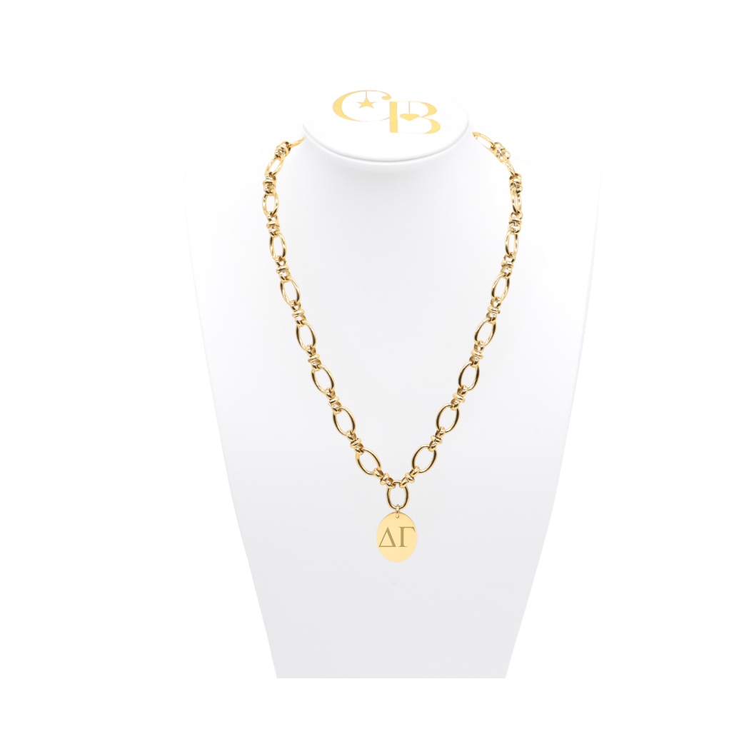 Delta Gamma gold large link evermore necklace with large oval charm displayed on white necklace bust front view with horizontal greek letters