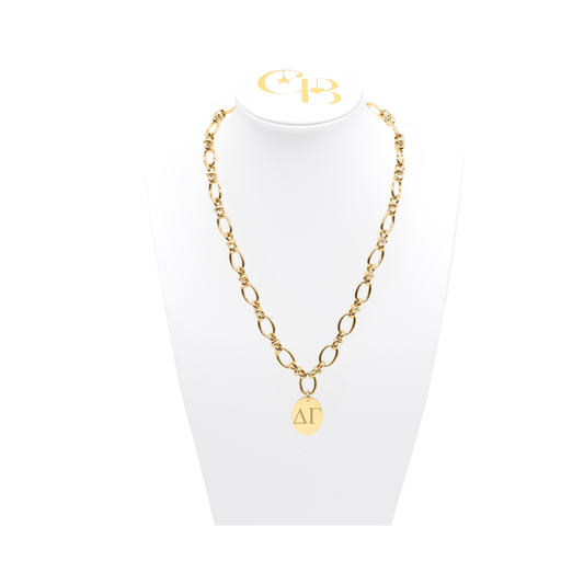 Delta Gamma gold large link evermore necklace with large oval charm displayed on white necklace bust front view with horizontal greek letters