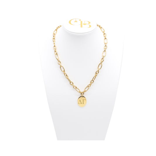 Delta Gamma gold large link keepsake necklace with large oval charm displayed on white necklace bust front view with horizontal greek letters