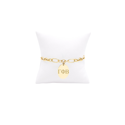 Gamma Phi Beta large link keepsake bracelet with large oval charm displayed on white pillow front view with horizontal greek letters