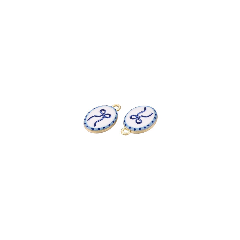 Gold Blue Bow Charm featuring a duel angled view of a delicate navy blue bow illustration on a white oval enamel background with a dotted blue border. 