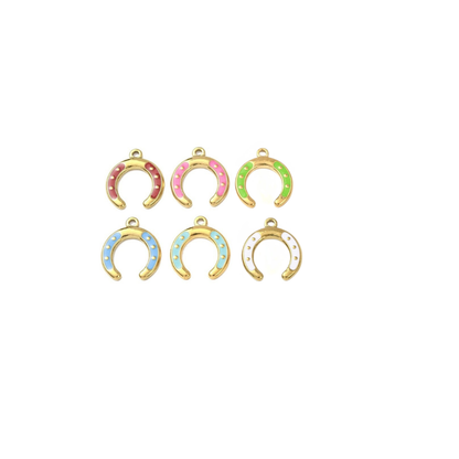 Assorted gold horseshoe charms with colorful enamel accents on a white background