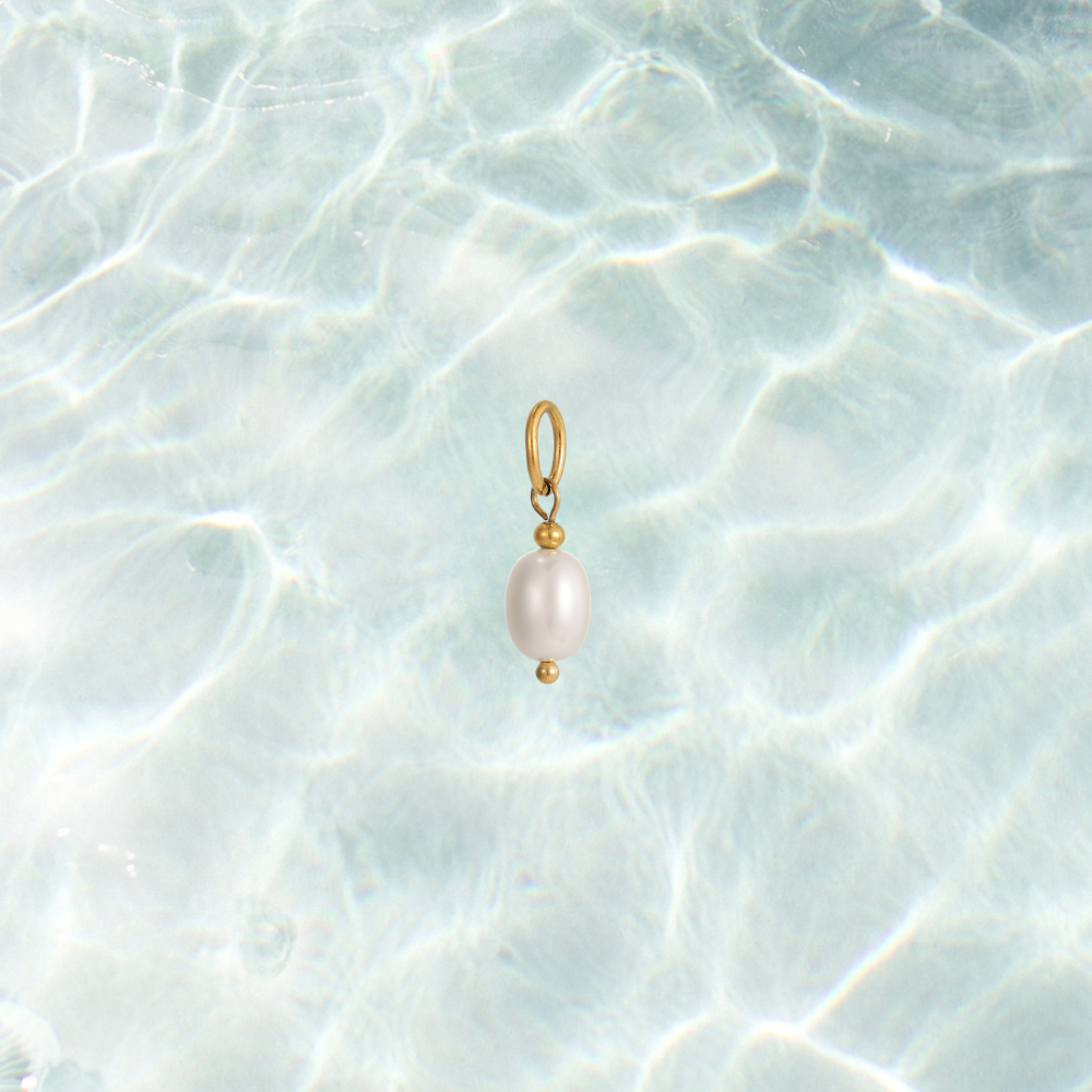 Gold dainty pearl drop charm on a waterproof background
