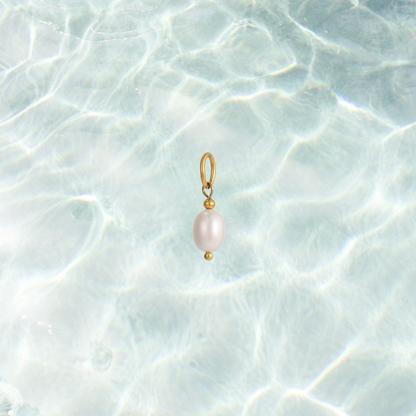 Gold dainty pearl drop charm on a waterproof background