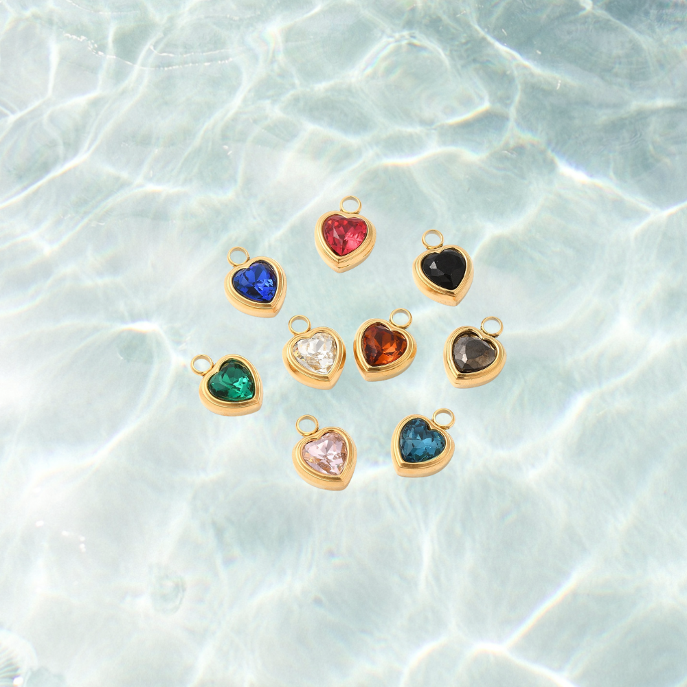 Gold heart assorted gemstone charm on a waterproof background