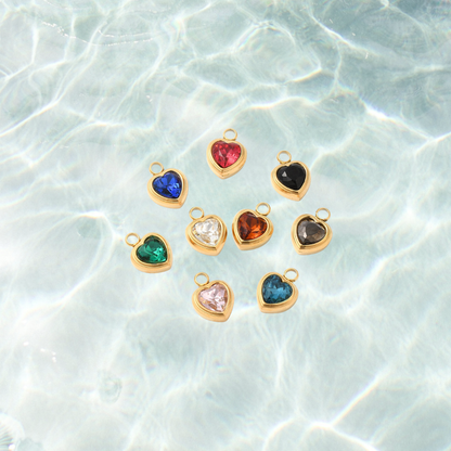 Gold heart assorted gemstone charm on a waterproof background
