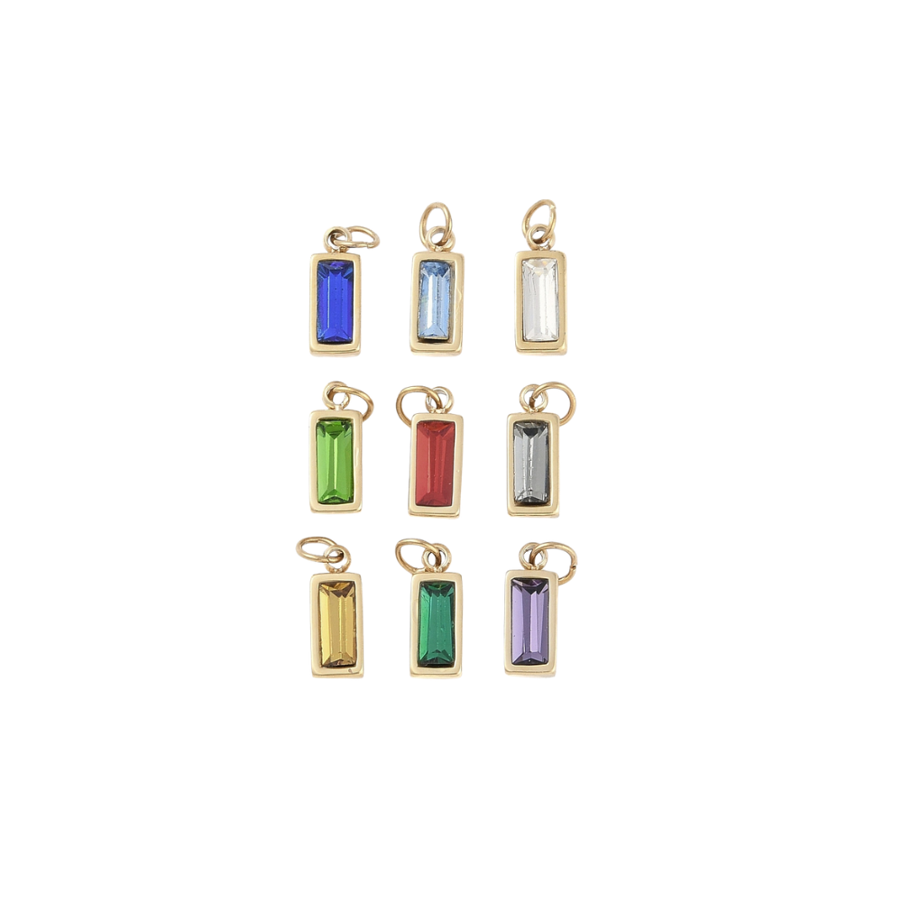 Gold jewel assorted gemstone charm on a white background