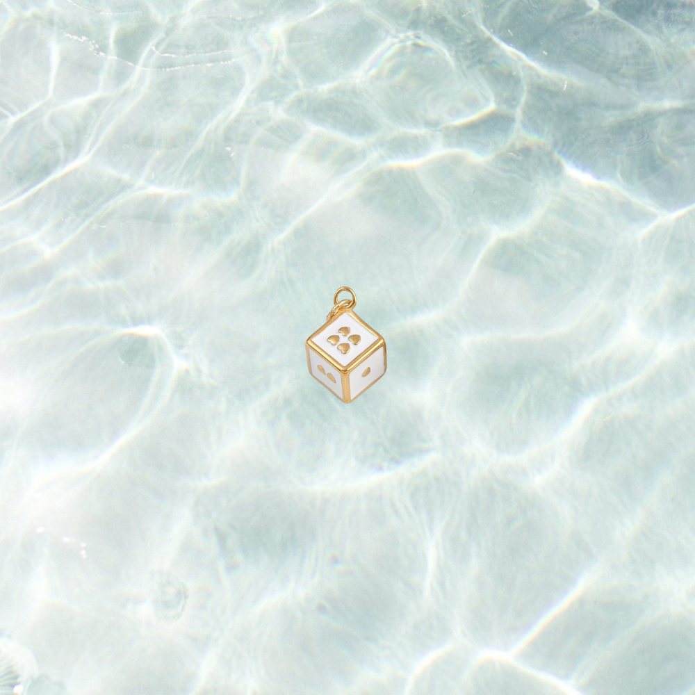 Gold lucky dice charm on waterproof background