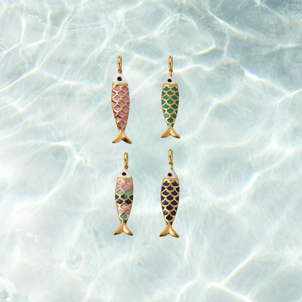 Four gold enamel fish charms featuring colorful scale patterns in dark pink, green, blue, and multicolor on a shimmering water background.