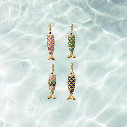 Four gold enamel fish charms featuring colorful scale patterns in dark pink, green, blue, and multicolor on a shimmering water background.