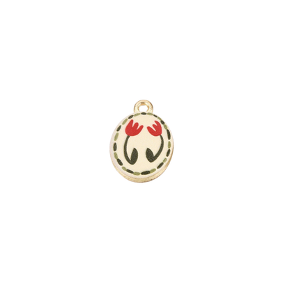 Gold oval charm featuring two red tulip illustrations with a dotted olive green border on a cream background