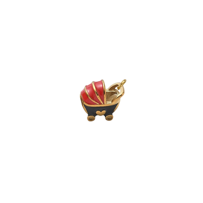 Gold vintage baby carriage charm featuring a red and black enamel baby stroller with gold accents on a white background.