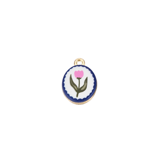 Gold oval charm featuring a pink flower illustration with navy scalloped order on a white background