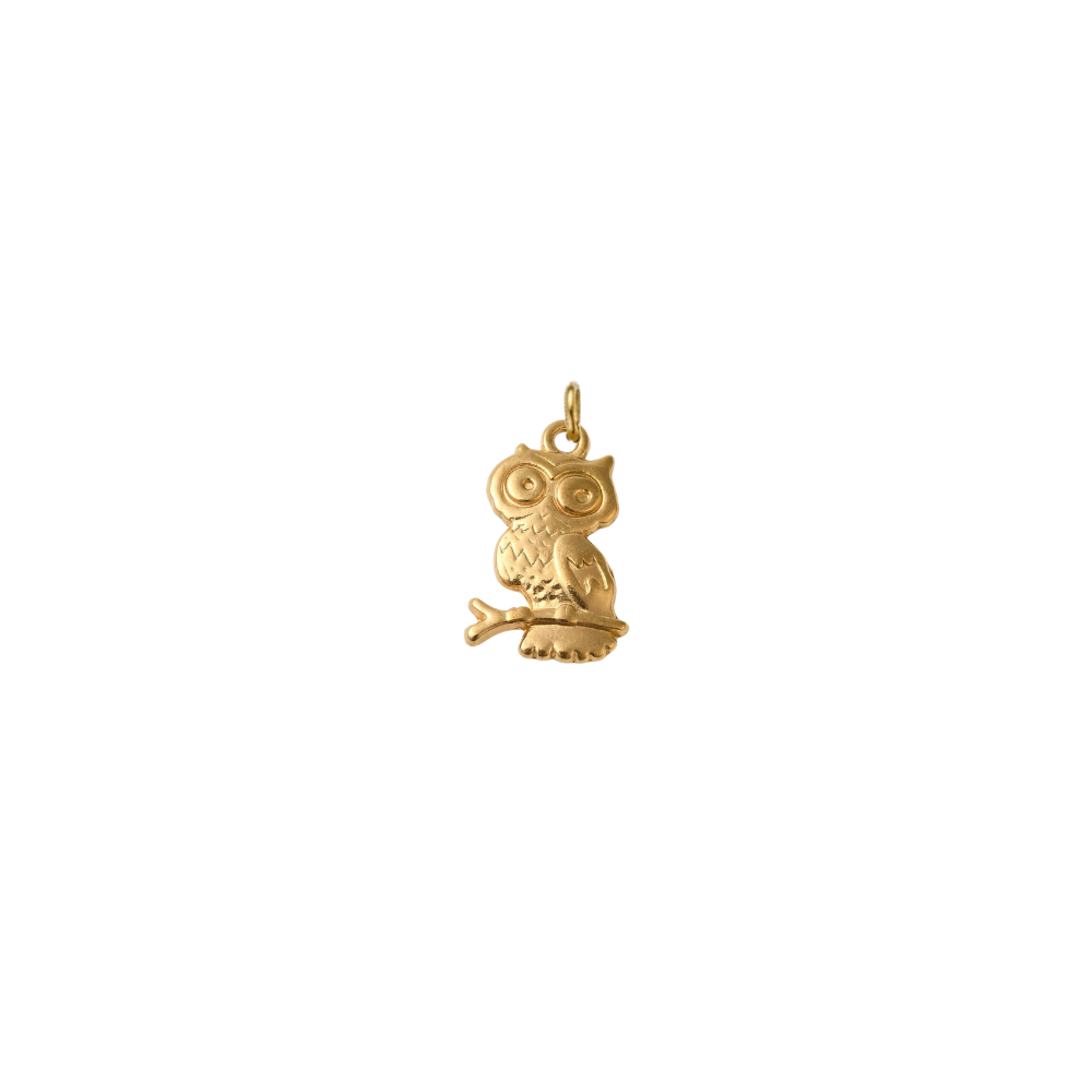 Gold owl charm with engraved feather details perched on a branch against a white background.