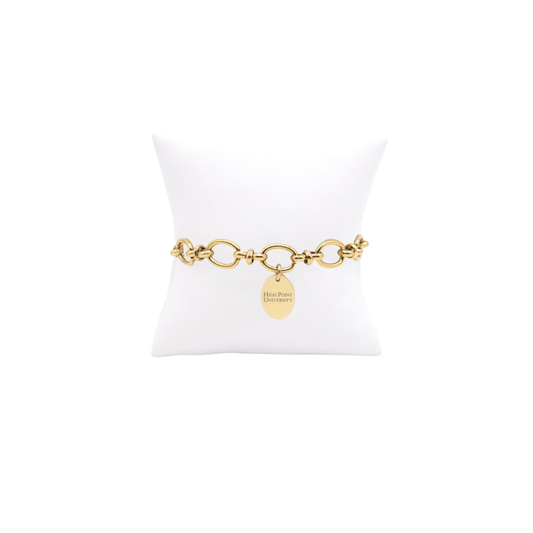 High Point University gold large link Evermore bracelet with small oval charm with high point university horizontal text on white pillow front view
